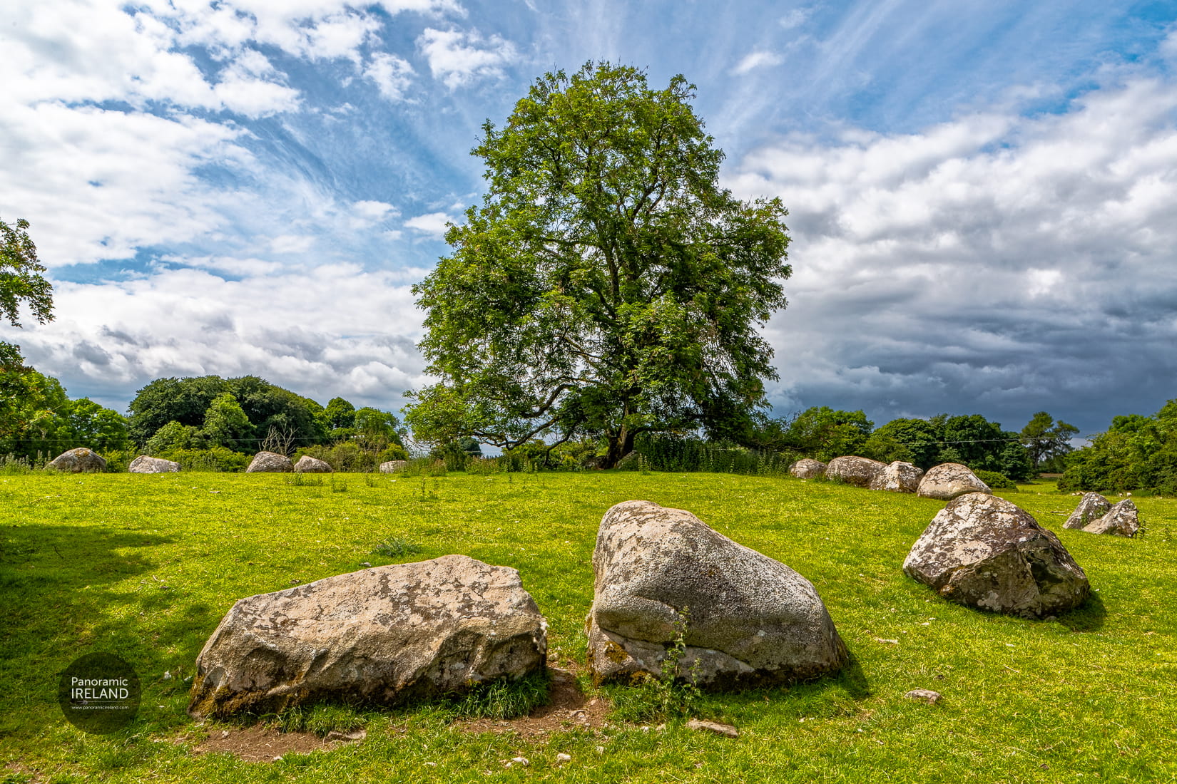 An ancient stone circle under a stormy summer sky in the Irish countryside