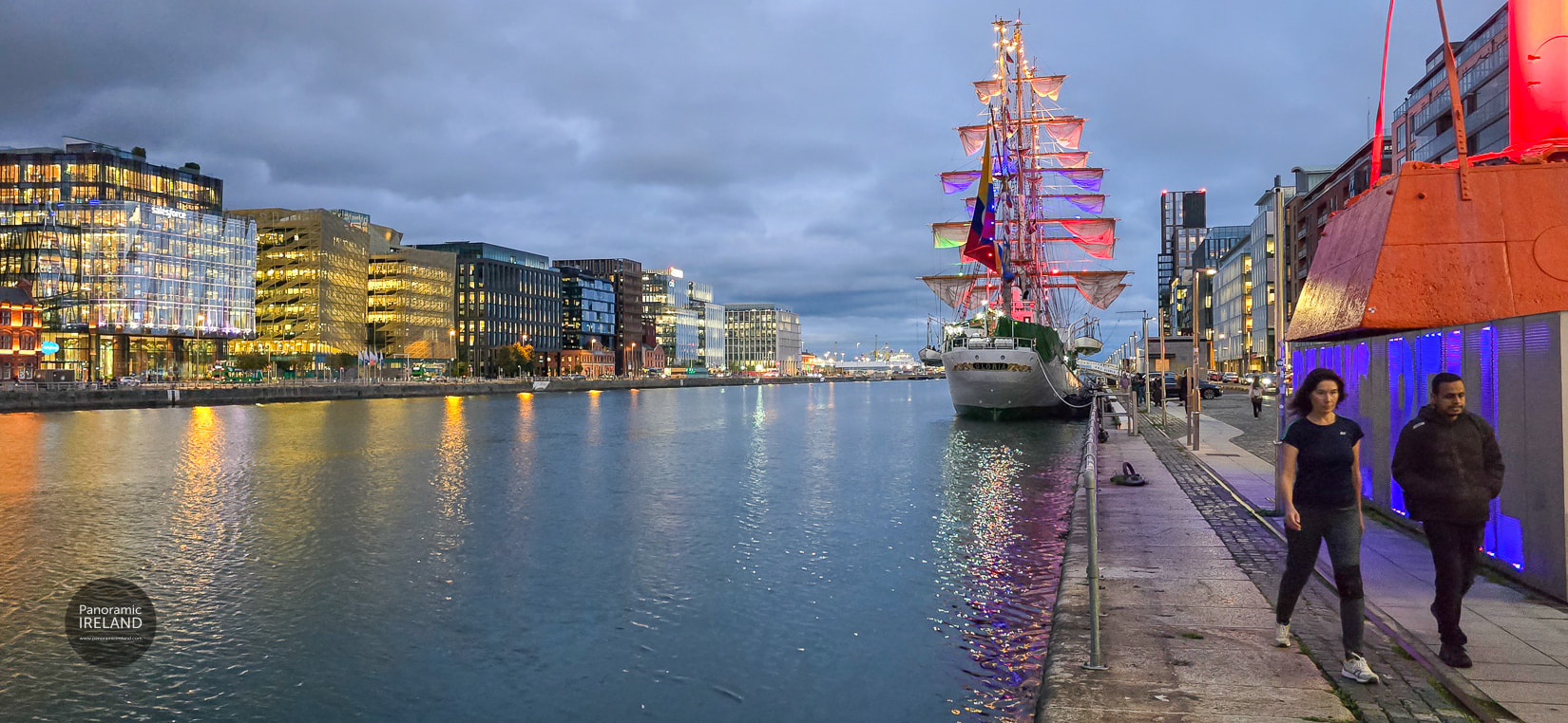 Night on the quays — Gloria's last hours in Dublin. ARC Gloria on the Liffey at night, Dublin Docklands lights