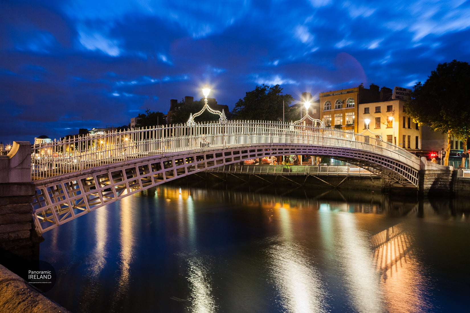 Ha'penny Bridge illuminated at night over the River Liffey, Dublin — long exposure photography by Panoramic Ireland
