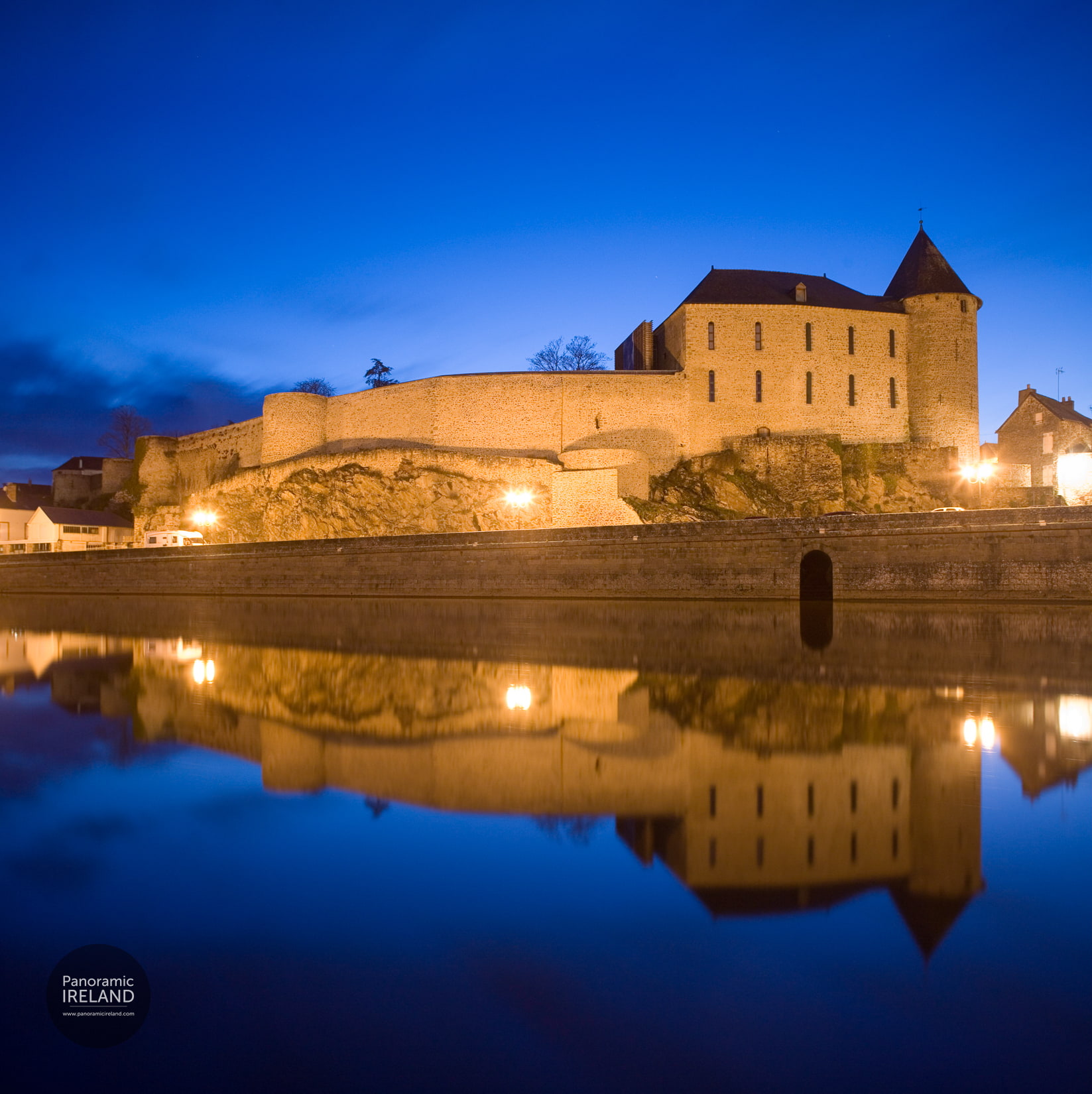 French château by a river at night — Panoramic Ireland